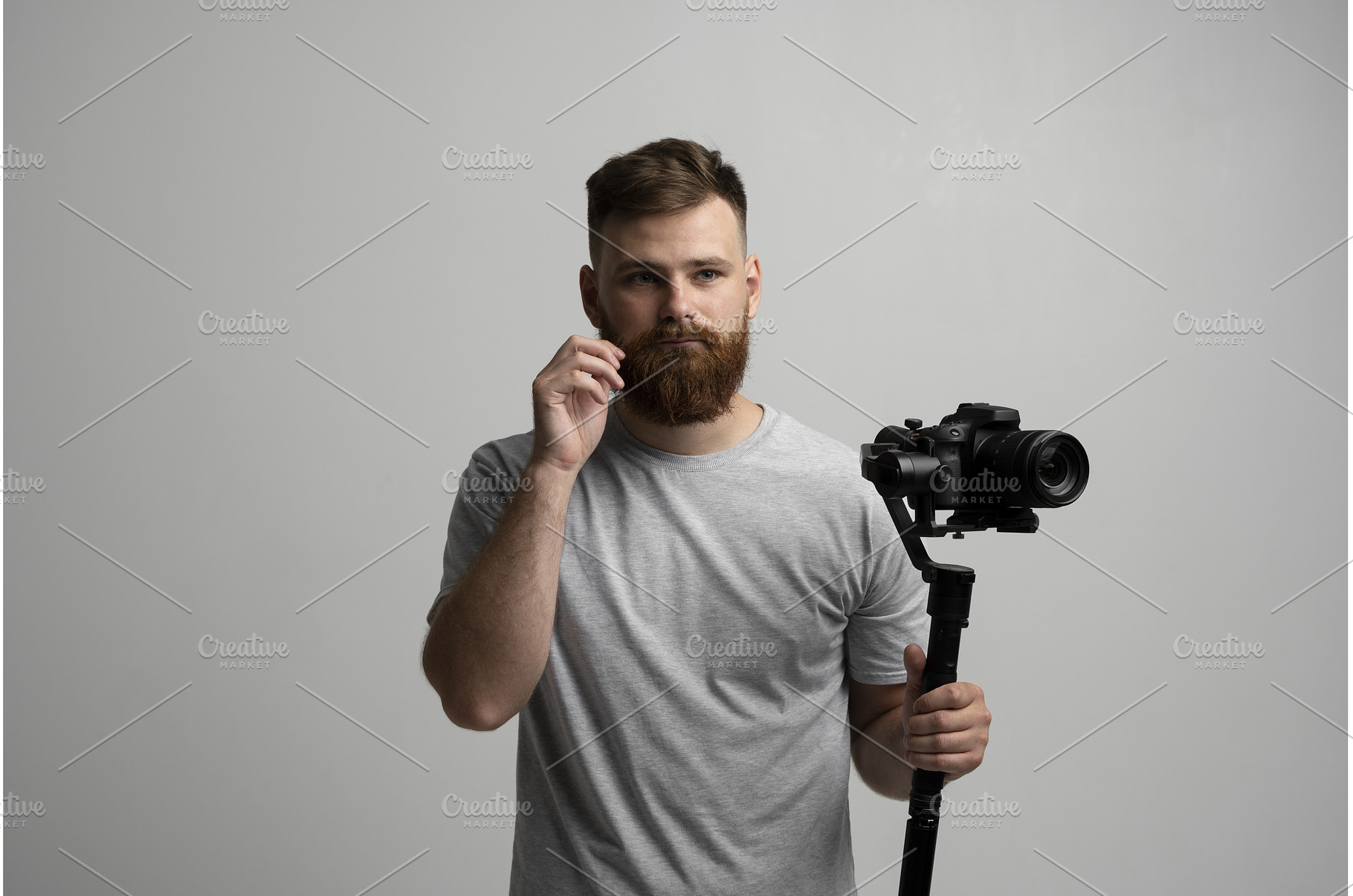 Bearded man holding professional, a Person Photo by volodymyrshtun13795