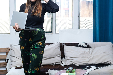 Beautiful business woman standing holding a laptop at home, a Person Photo by 2Design
