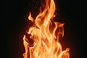 Bright flames dance in a black background, creating warmth and energy during a, an Arts & Entertainment Photo by AlyaAnd