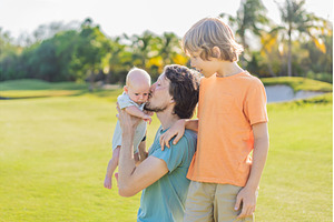 Father, older son, and newborn baby, a Person Photo by Elizaveta Galitskaya