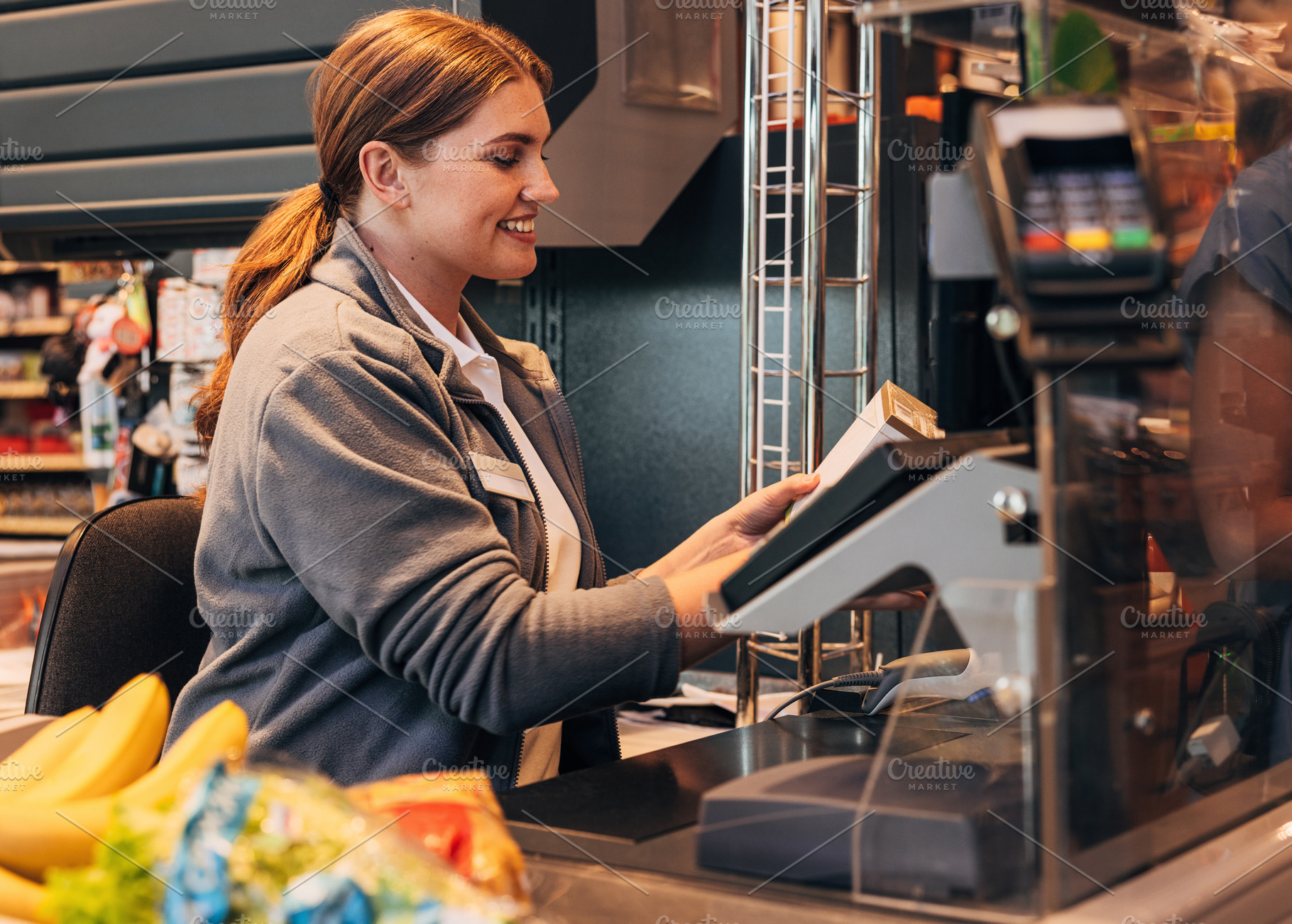 Side view of a cheerful cashier, a Person Photo by Artem Varnitsin