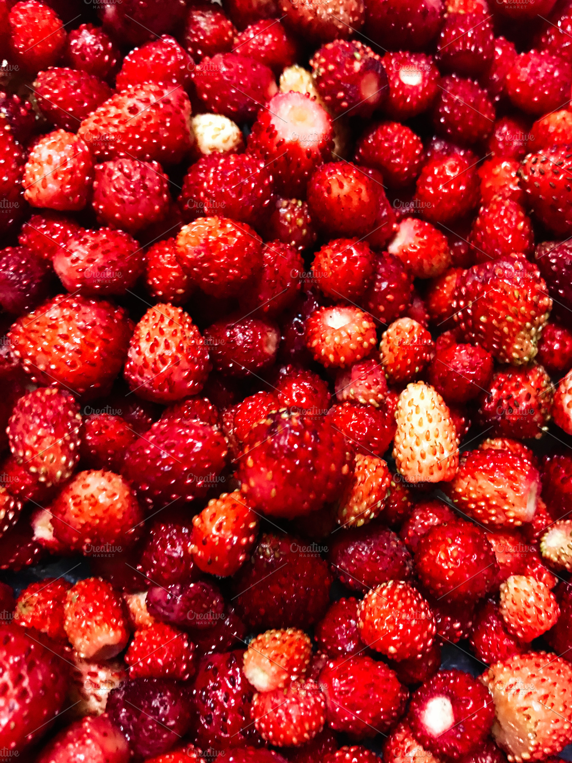 Close-up of fresh wild strawberries with vibrant red color, a Photo by AS photostudio
