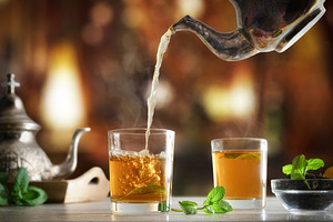 Pouring Moroccan tea into a glass in a tea room, a Food & Drink Photo by Davizro's Market
