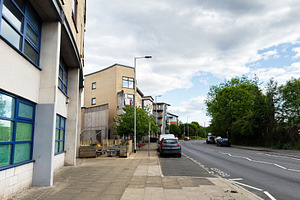 Quiet urban street in Manchester, UK with modern apartment build