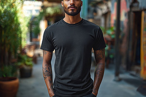 Confident man poses in urban courtya, a Photo by Tanuart