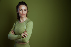 Middle-aged woman in green workout gear, a Person Photo by Alliance Images