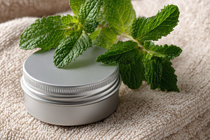 Mint cream jar on beige towel spa re, a Photo by Pixeness Studio