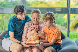 Happy family celebrating their, a Person Photo by Elizaveta Galitskaya