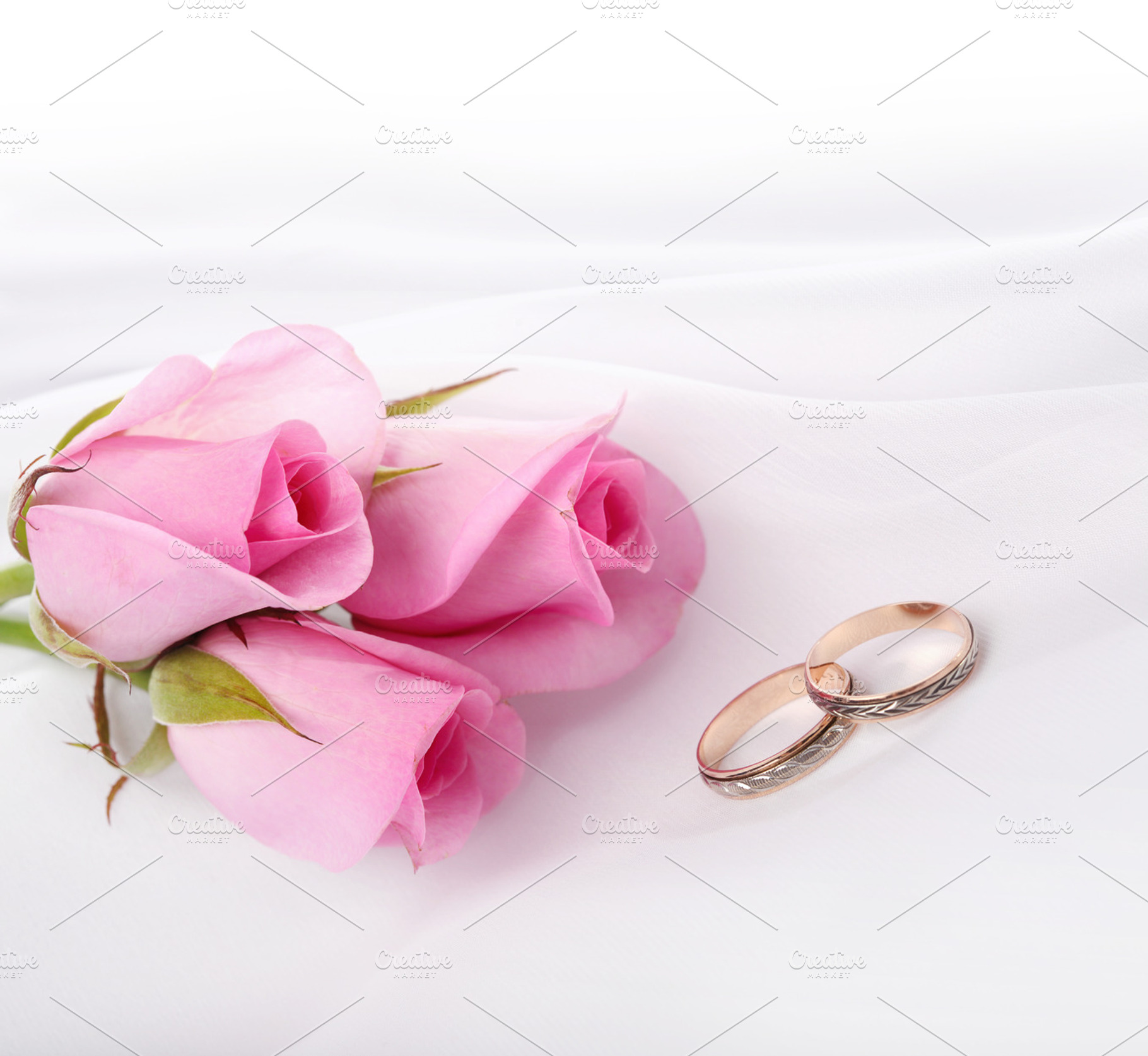 wedding rings and pink roses, a Photo by Liliia Rudchenko