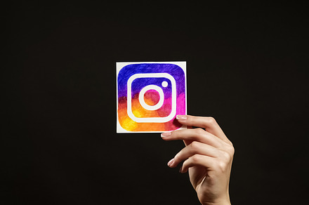 Instagram logo online app digital marketing hand, a Person Photo by Photo Drive Studio