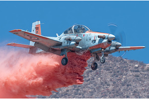 A white aircraft releases fire, a Transportation Photo by ZinetroN