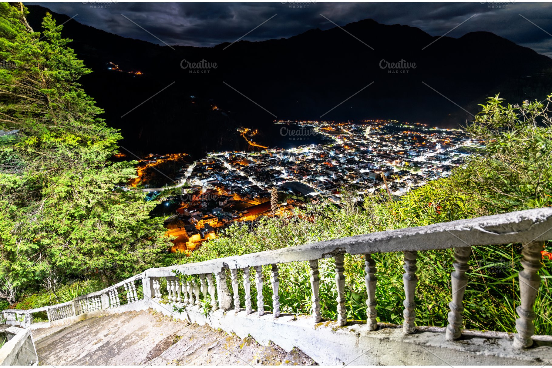 Illuminated city of Banos at night, Ecuador, an Architecture Photo by Leonid Andronov