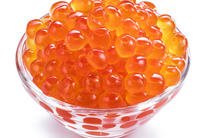 Red caviar in the bowl on white back, a Photo by Volff