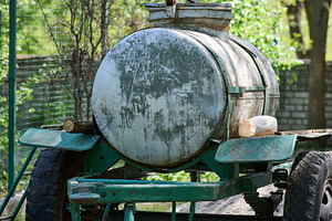 An old metal tank on a trailer, covered with traces of rust and, a Transportation Photo by ndanko