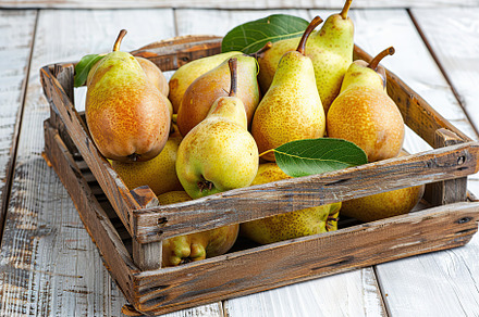 Ripe pears in crate on white wooden table, a Food & Drink Photo by AlyaAnd