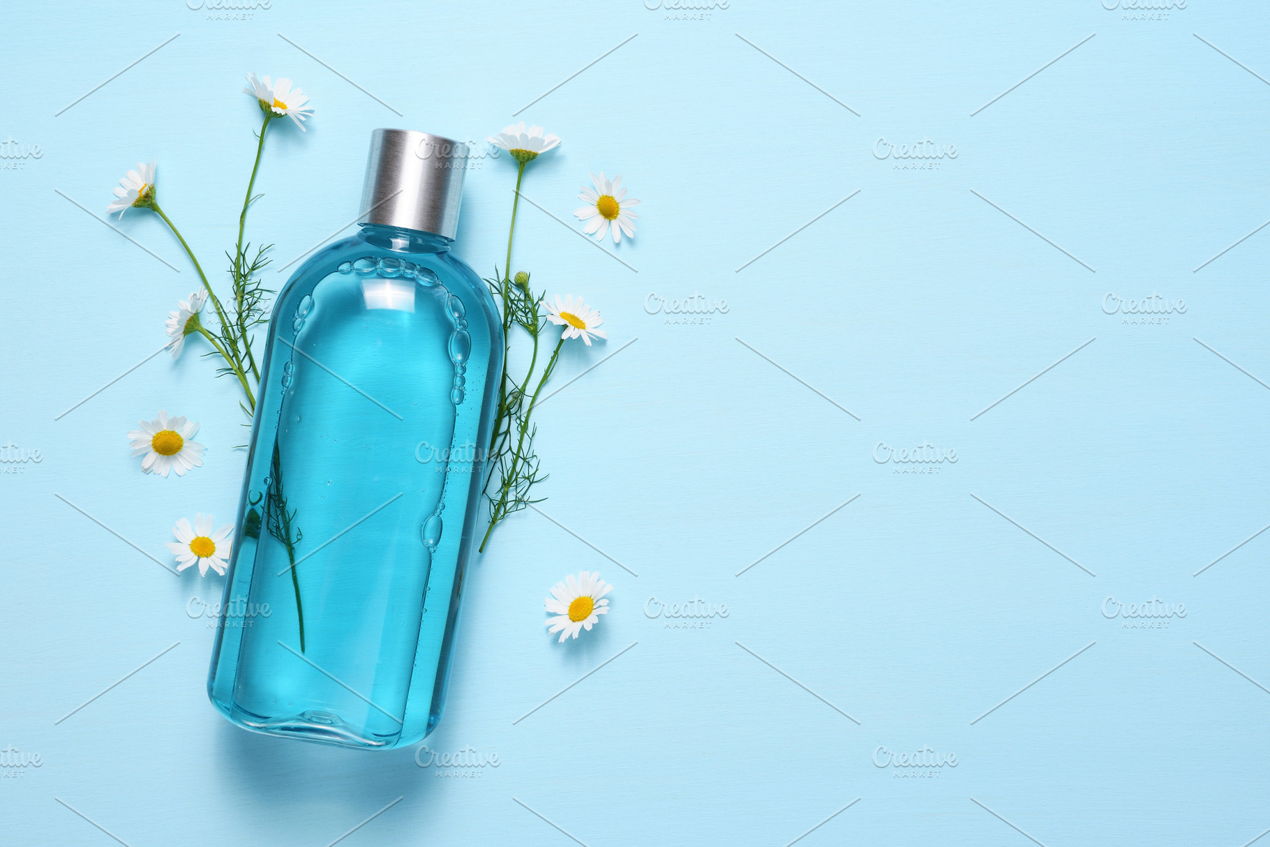 Cosmetic bottle on blue, a Beauty & Fashion Photo by Anatoliy Sadovskiy