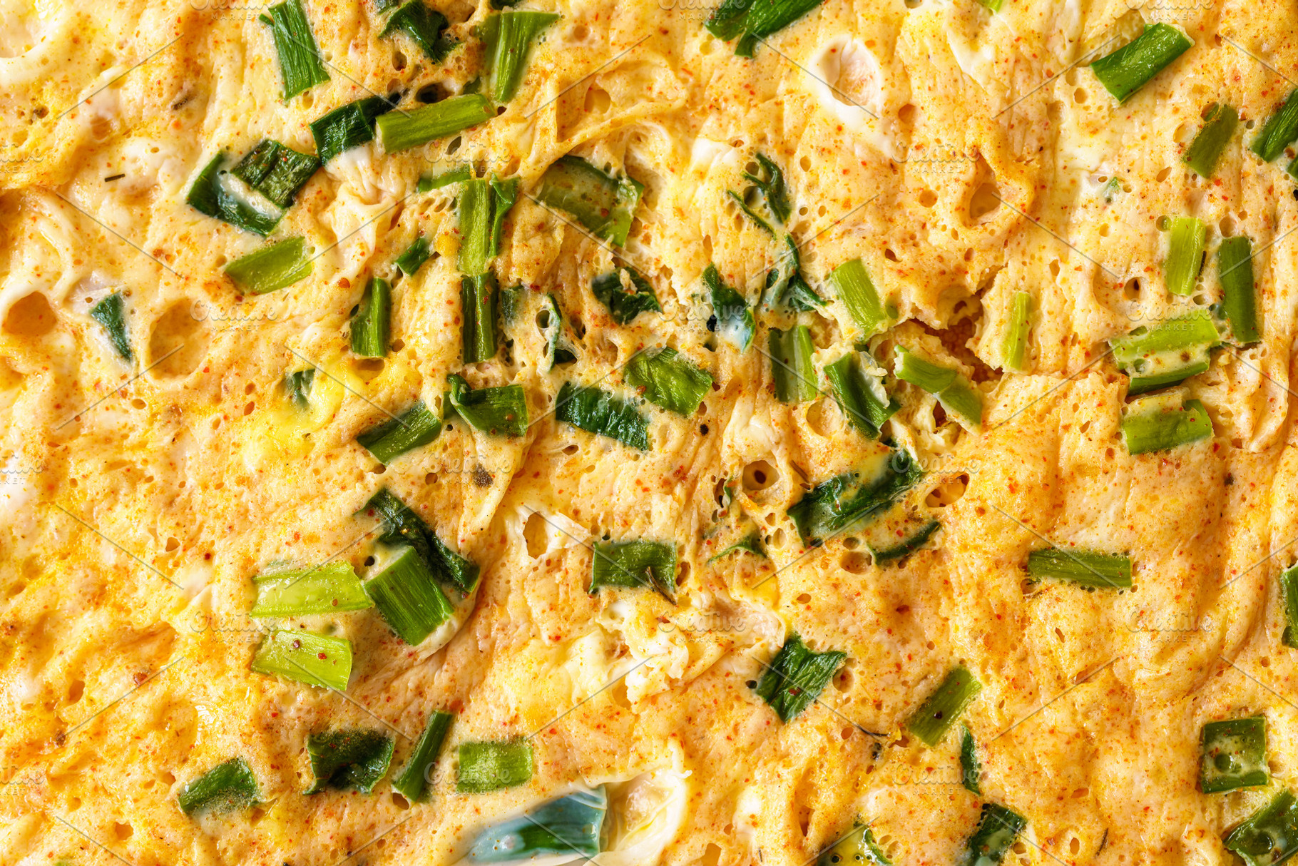 Macro shot capturing the texture of a homemade omelet cooked with fresh green o, a Food & Drink Photo by Eugene_Photo