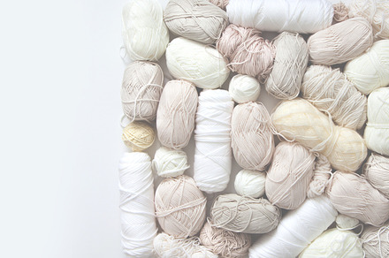 White, light, neutral yarn for knitting. Top view.
