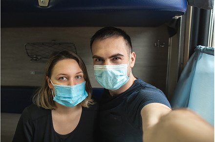 Couple in medical masks sitting in, a Person Photo by Northern Life