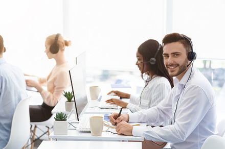 Attractive call center operator smil, a Photo by Prostock-Studio
