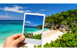 A hand holding a photo of a tropical, a Nature Photo by Igor Tichonow
