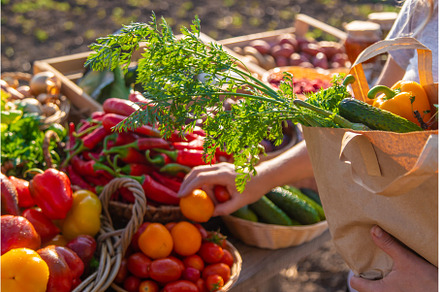 A woman buys fruits and vegetables, a Food & Drink Photo by yanadjana