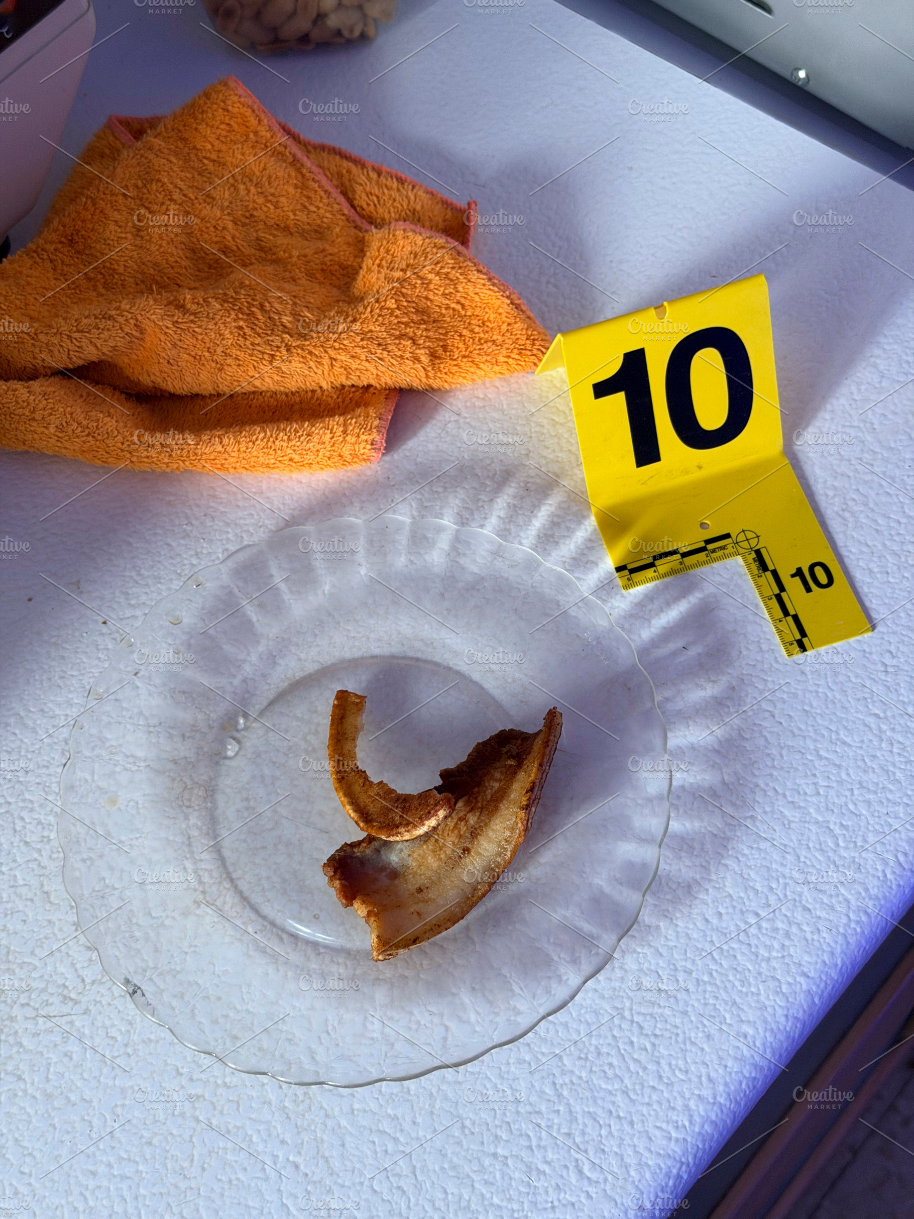 Forensic investigation examining bacon rind evidence on plate, an Industrial Photo by karrastock