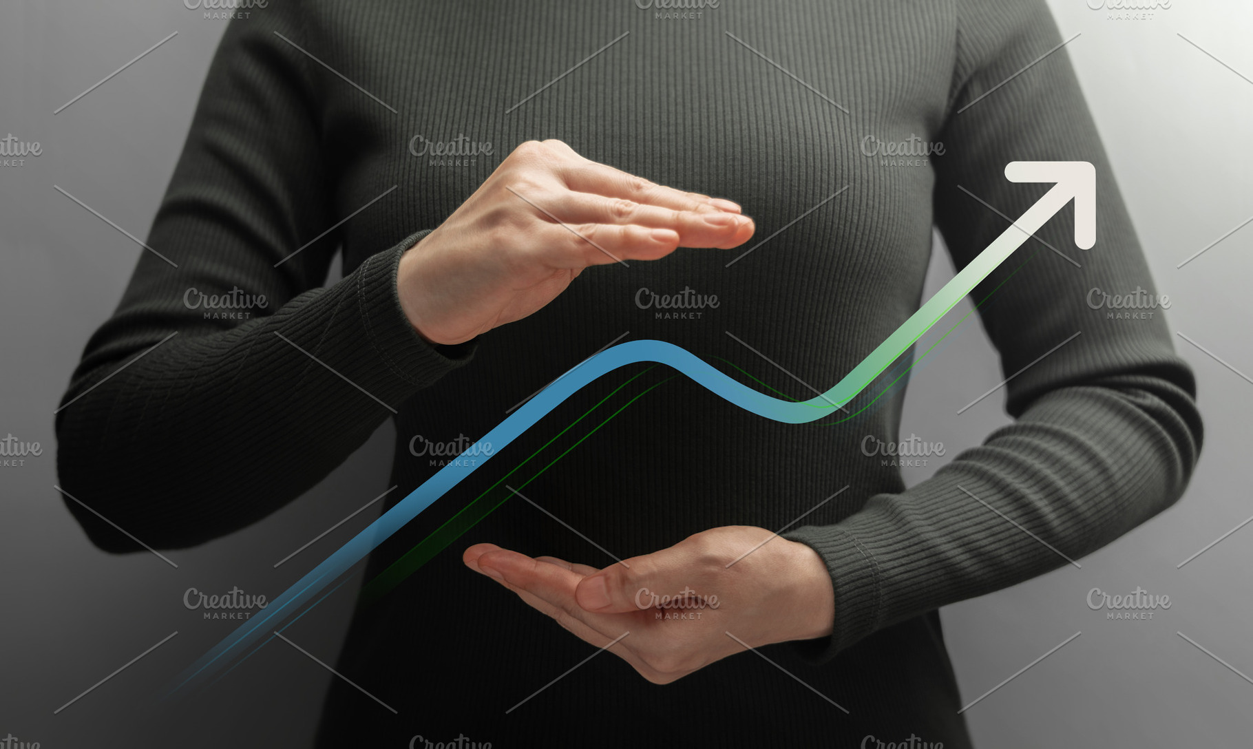 Businesswoman shields a rising graph between her hands, a Photo by salmon.black