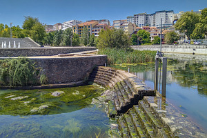 Urban river edge with moss and stair access, an Architecture Photo by DanFLCreativo