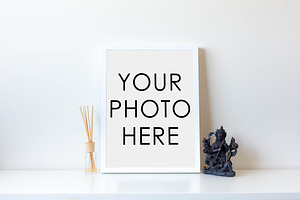 White Frame With Statue and Diffuser