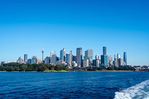 Sydney skyline view with skyscrapers and blue sky from the water, an Architecture Photo by GoodGoods