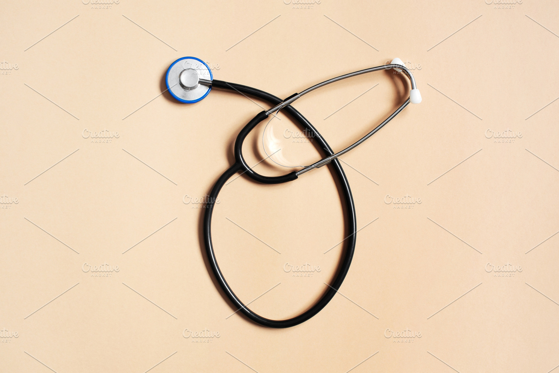 Stethoscope on the beige background, a Health & Medical Photo by AlinaKho
