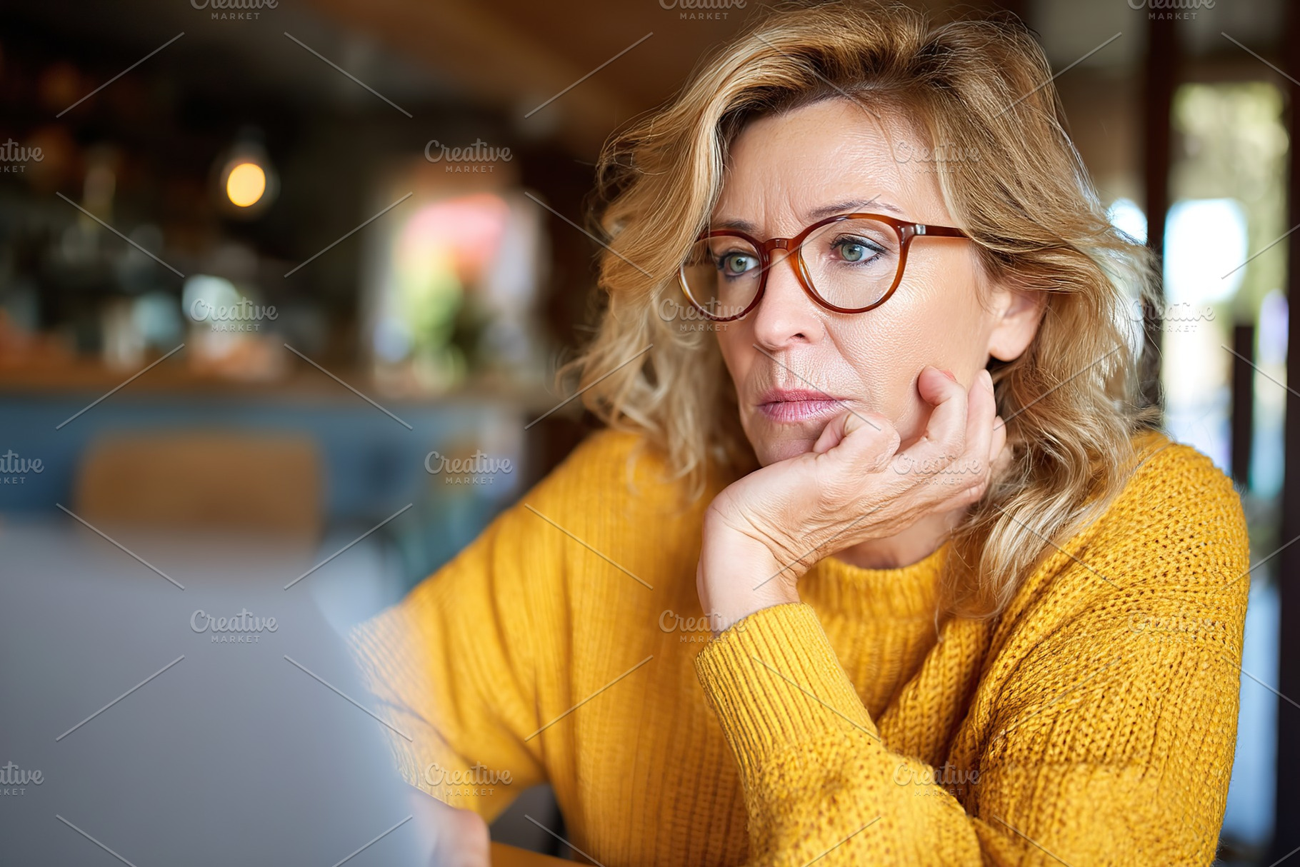 Woman focused on laptop while seated in a cozy cafe working during afternoon ho, a Person Photo by AlyaAnd