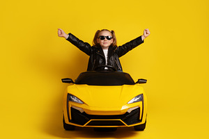 Young girl in black leather jacket and sunglasses sitting in a y, a Person Photo by Ales Munt