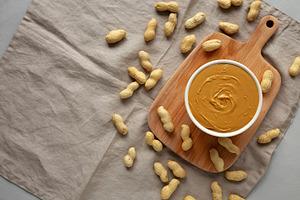 Organic Peanut Butter in a Bowl, top view. Flat lay, overhead. C, a Food & Drink Photo by LiudmylaChuhunova