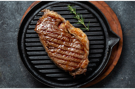 Fried strip loin steak on vintage, a Food & Drink Photo by LARISA BLINOVA