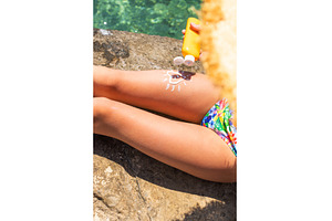 The child has sunscreen on his legs