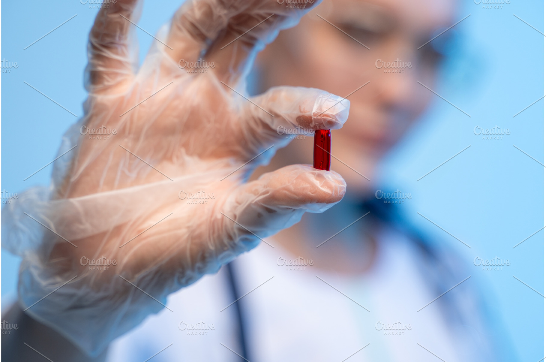 Hand in clear glove holding red, a Health & Medical Photo by volodymyrshtun13795