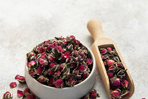 Dried rose buds with wooden scoop for herbal tea, a Food & Drink Photo by Olena Rudo