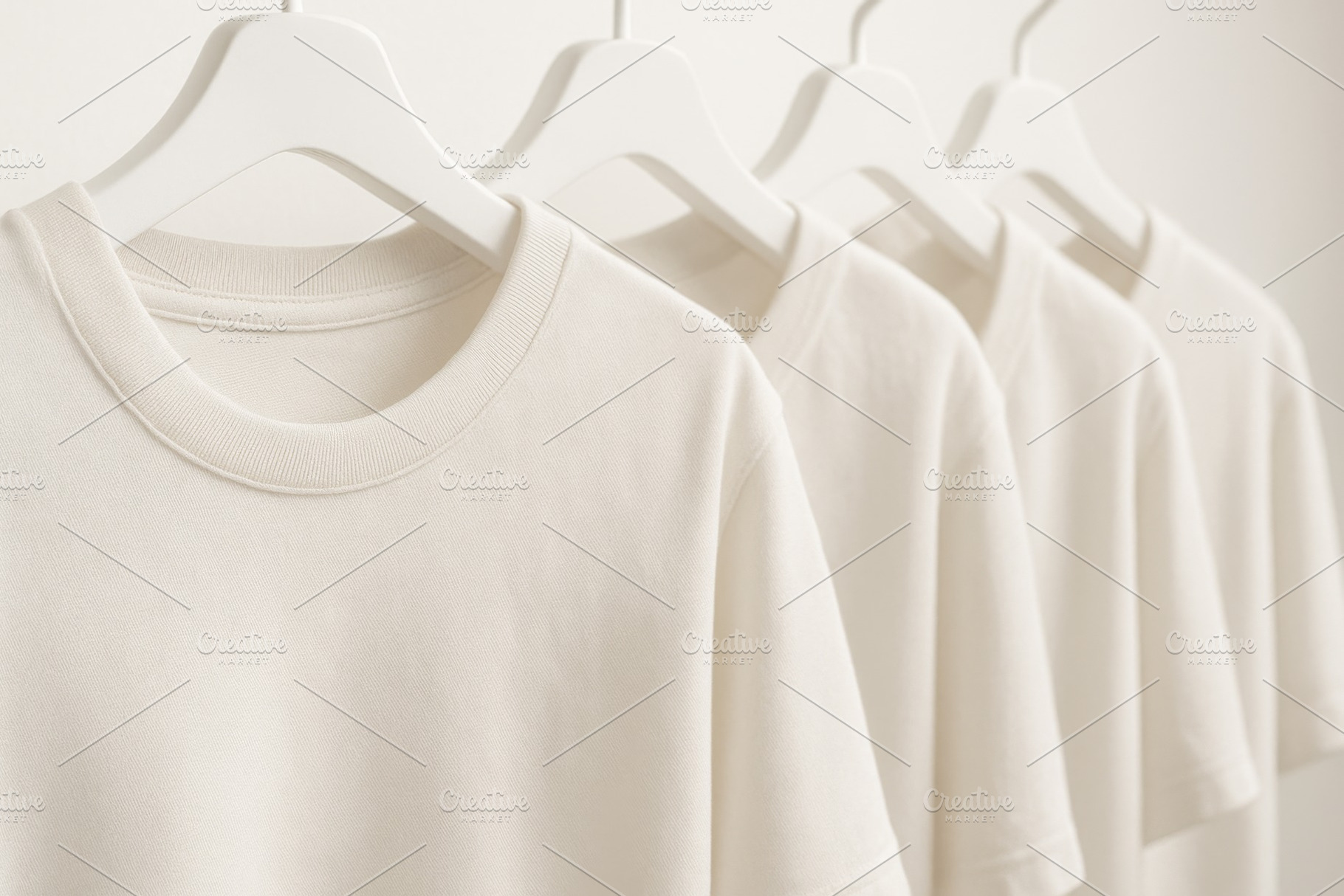 White t-shirts on hangers in minimal interior, texture backgroun, a Photo by Dvoevnore photos