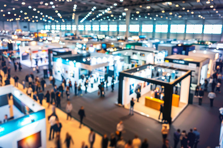 Busy exhibition hall filled with att, a Photo by Tanuart