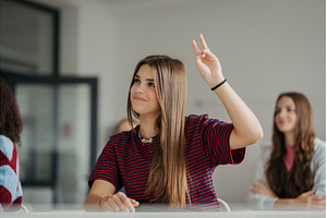 Girl student raising a hand to, a School & Education Photo by HalfPoint