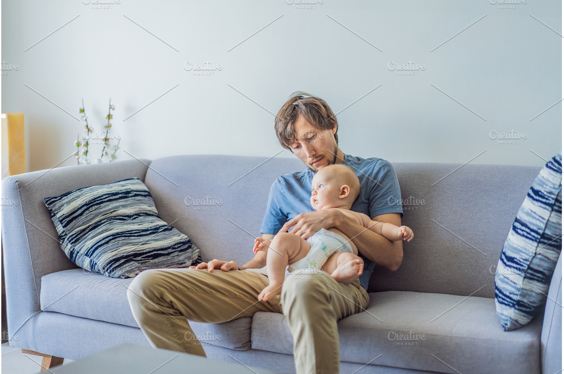Tired father falling asleep on couch, a Person Photo by Elizaveta Galitskaya