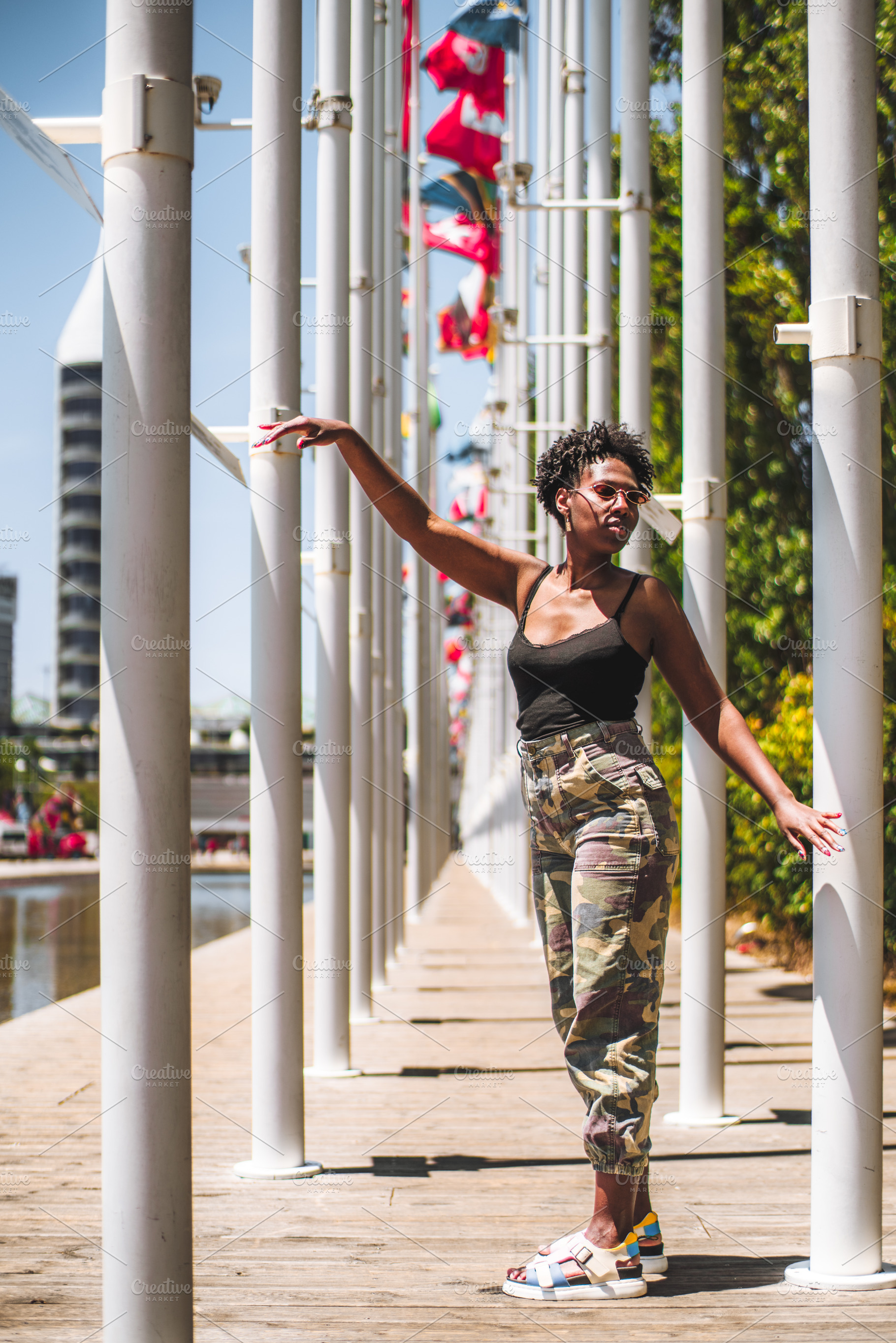 Woman Posing Among Flagpoles, a Person Photo by SkyNext