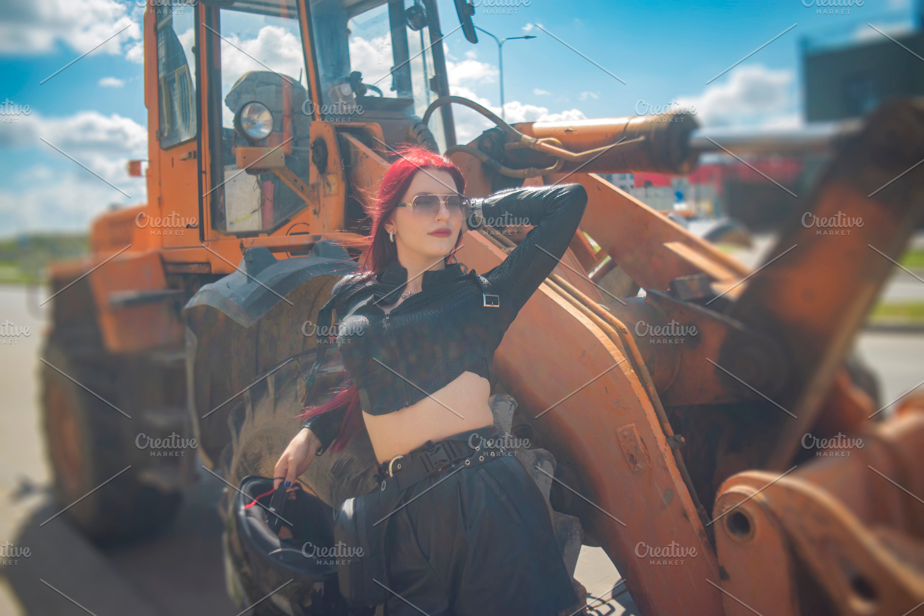 Red haired woman posing near heavy industrial loader with cloudy, a Photo by Pictures for you!!!!!!!!!