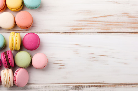 Colorful macarons dessert on white wooden background, a Food & Drink Photo by AlyaAnd