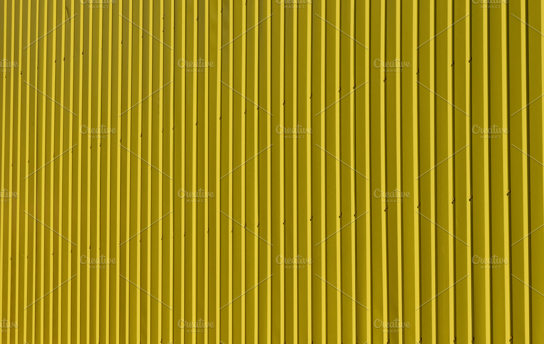Bright texture of vertical metal siding painted yellow., a Background Photo by ndanko