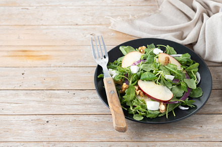 Autumn salad with apples and walnuts on wooden table, a Food & Drink Photo by etorres69