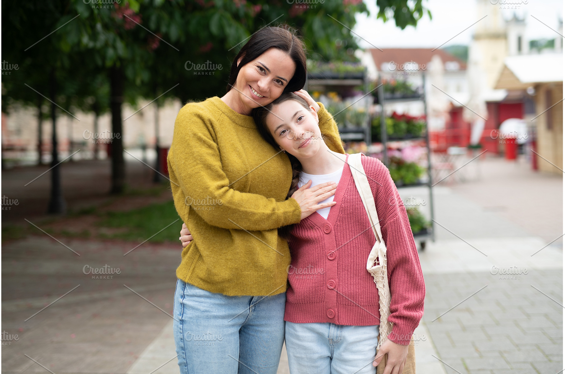 Mother embracing daughter while, a Person Photo by HalfPoint