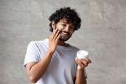 Cheerful indian man applying cream on face, holding moisturizer jar in hand, sm, a Photo by Prostock-Studio (Thumbnail 3 of 4)